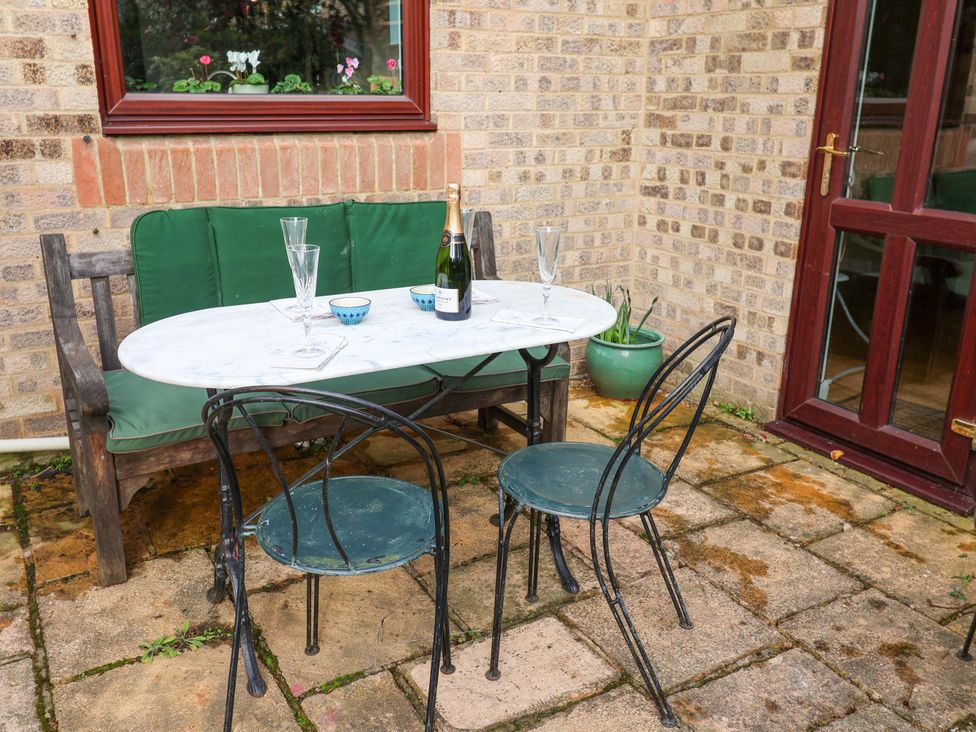 A table with chairs and champagne on a patio at 17 Demesne Gardens in Ipswich