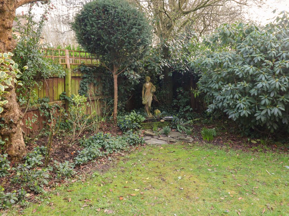 A garden with a statue and shrubs at 17 Demesne Gardens, Ipswich