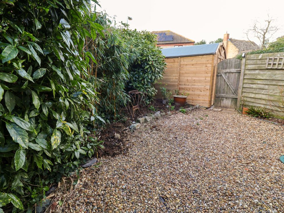 A garden with gravel and a wooden shed at 17 Demesne Gardens in Ipswich