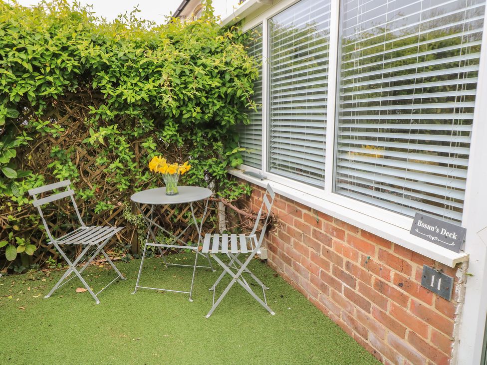 A outdoor area with a table and chairs at Bosun's Deck in Christchurch