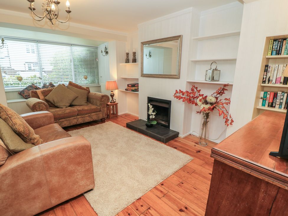 A living room with a sofa and coffee table at Bosun's Deck in Christchurch