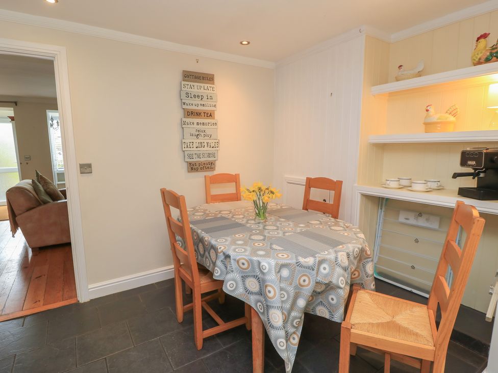 A dining room with a table and chairs at Bosun's Deck in Christchurch
