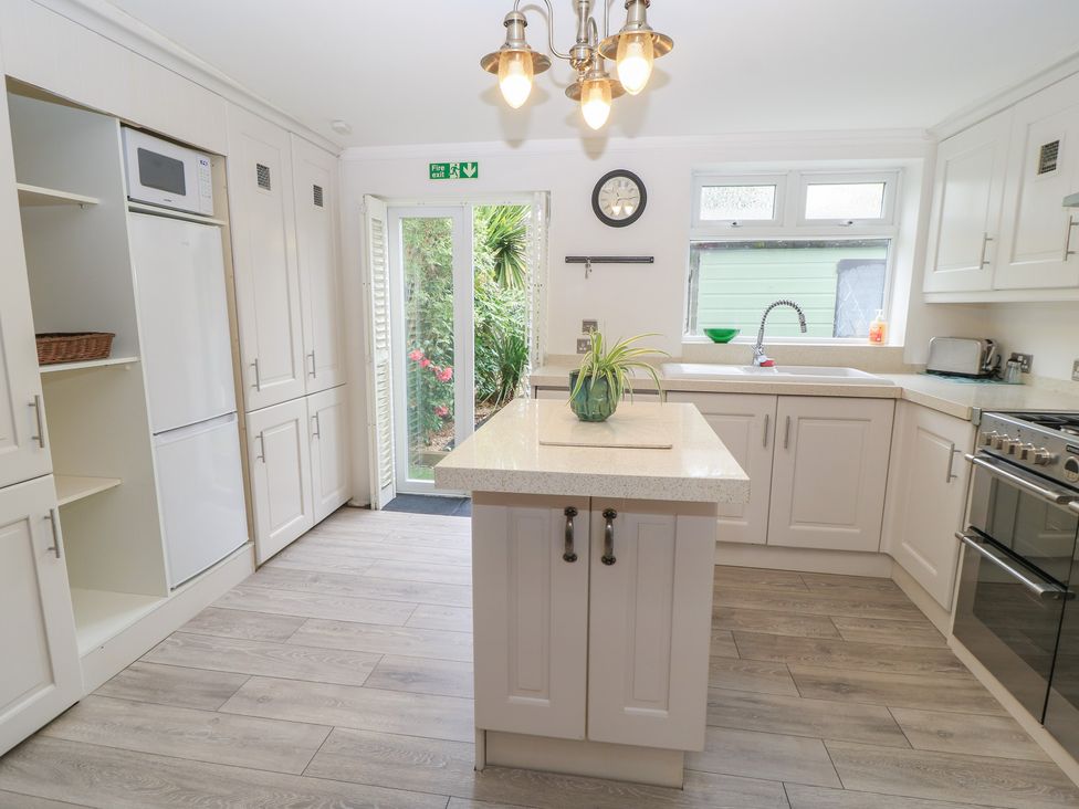 A kitchen with appliances and an island at Bosun's Deck in Christchurch