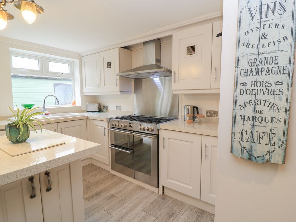 A kitchen with a stove and sink at Bosun's Deck in Christchurch