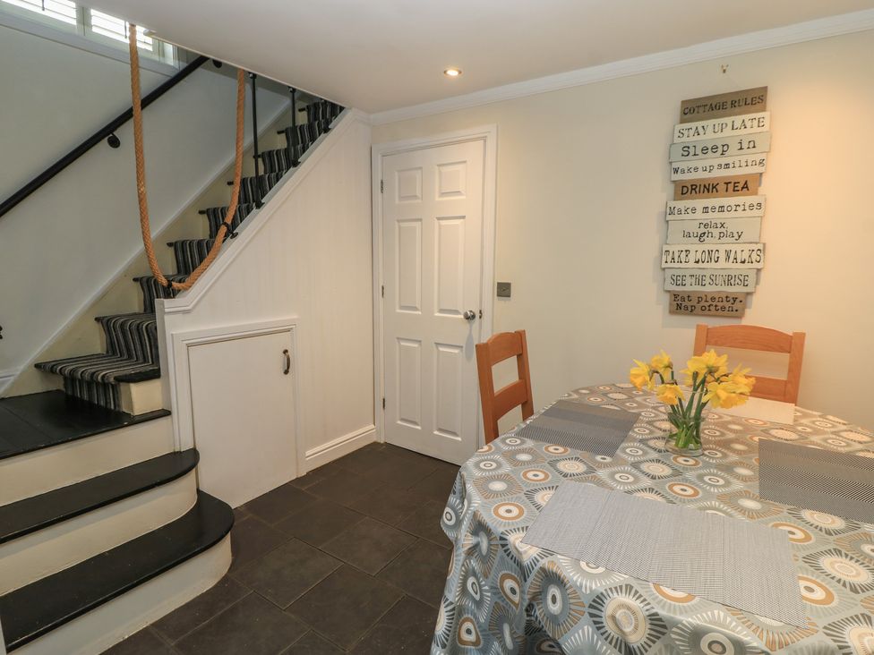 A dining room with a table and chairs at Bosun's Deck in Christchurch