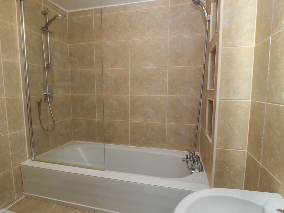 A bathroom with a bathtub and shower at Bosun's Deck in Christchurch