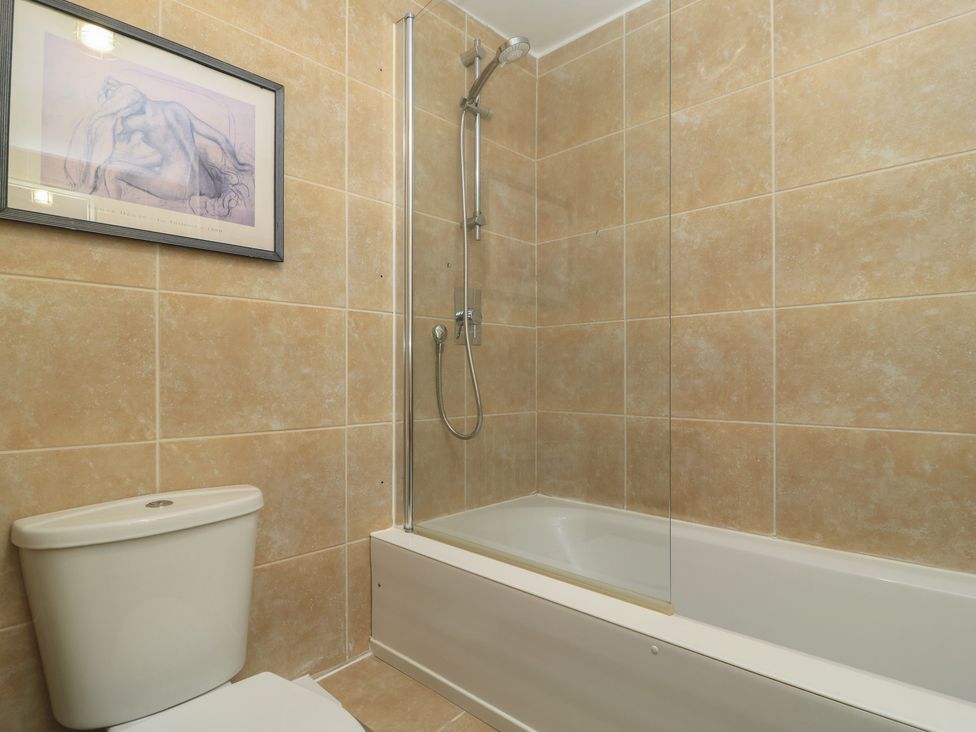 A bathroom with a bathtub and shower at Bosun's Deck in Christchurch