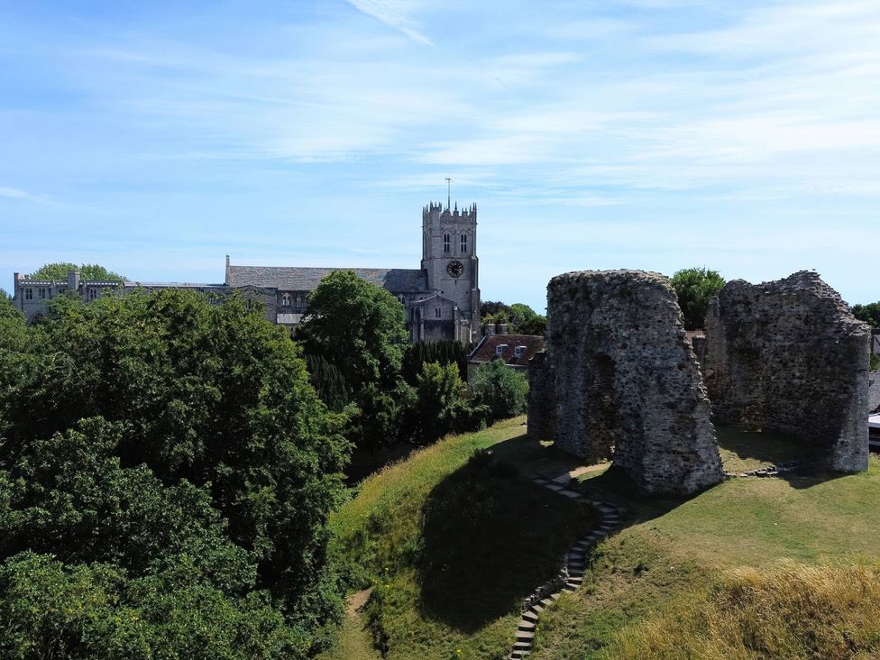 An image of ruins with trees and a clock tower nearby at Bosun's Deck in Christchurch
