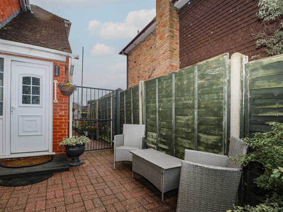 A garden area with a door, fence and patio furniture at The Annex in Slough