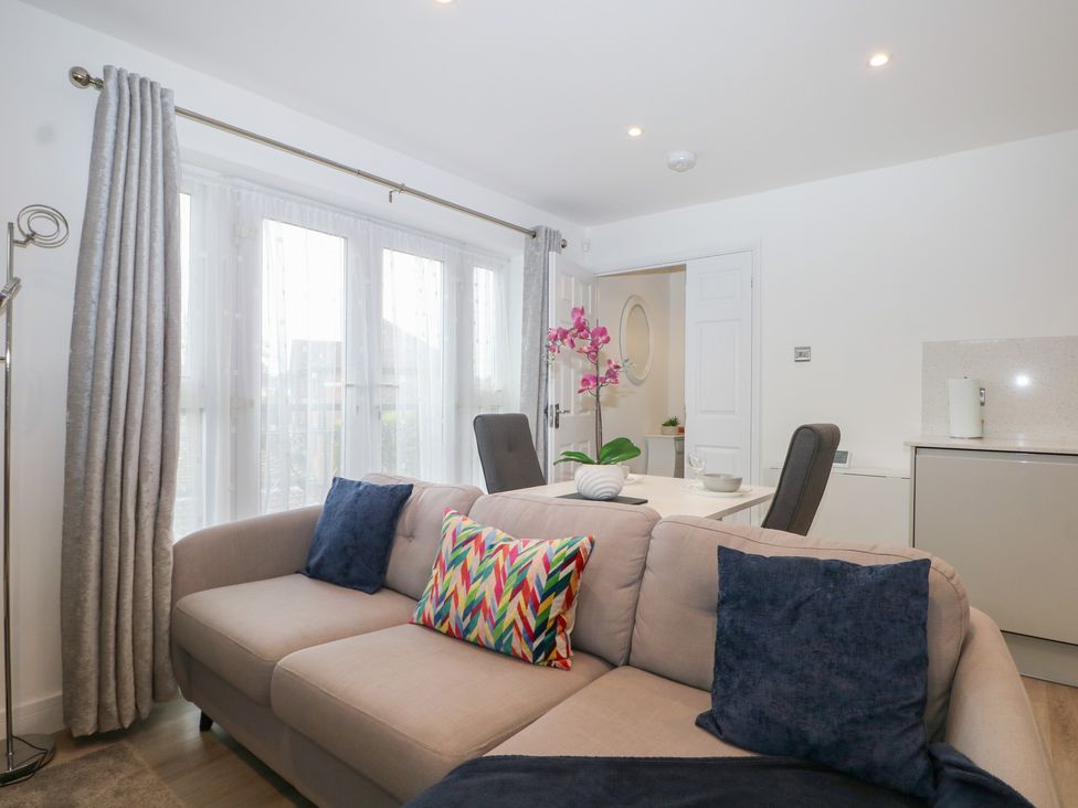 A living room with a sofa and dining table at The Annex in Slough