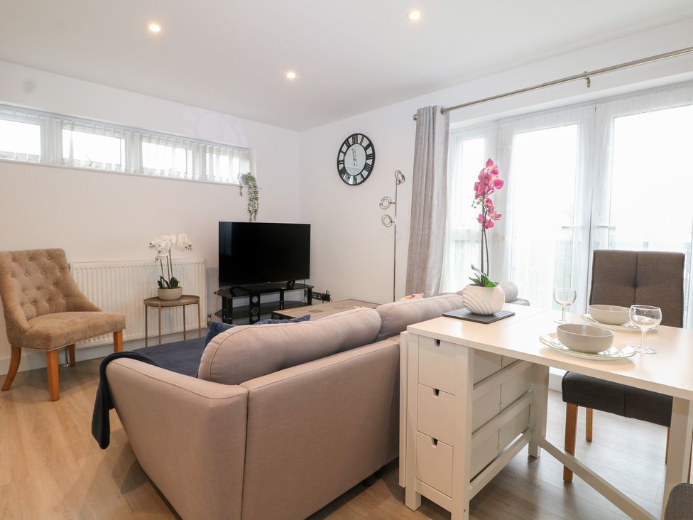 A living room with a sofa and television at The Annex in Slough