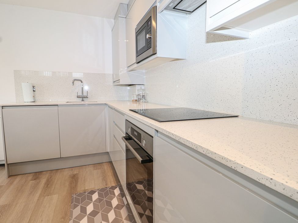 A kitchen with modern appliances and countertops at The Annex in Slough