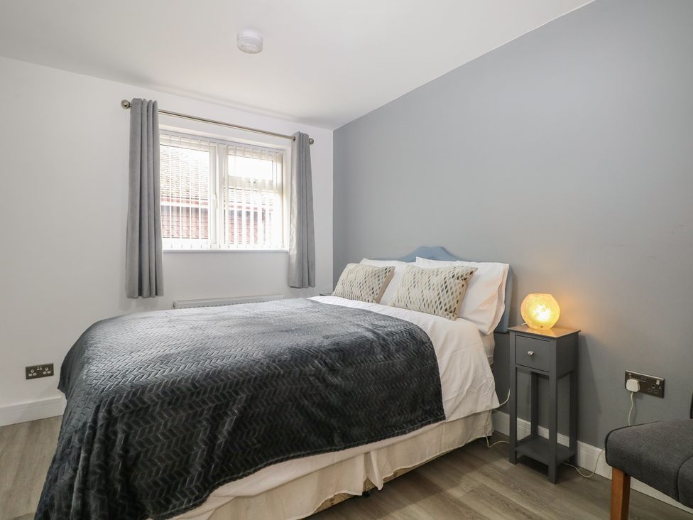 A bedroom with a bed and bedside table at The Annex in Slough