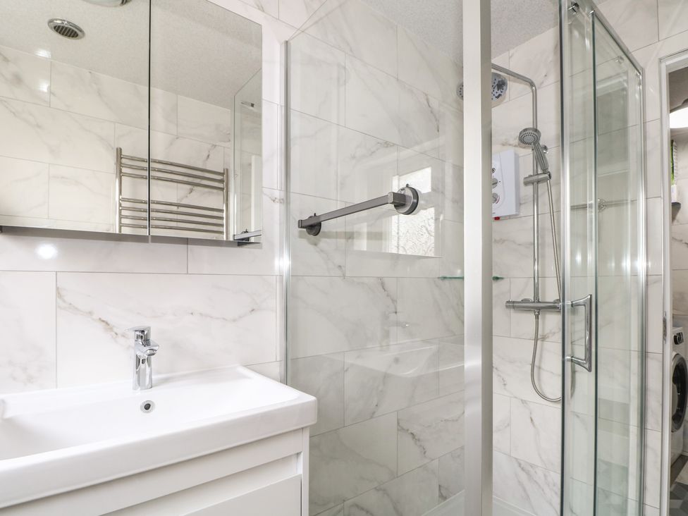 A bathroom with a sink and shower at The Annex Slough