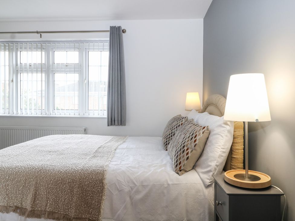 A bedroom with a bed and lamp at The Annex in Slough
