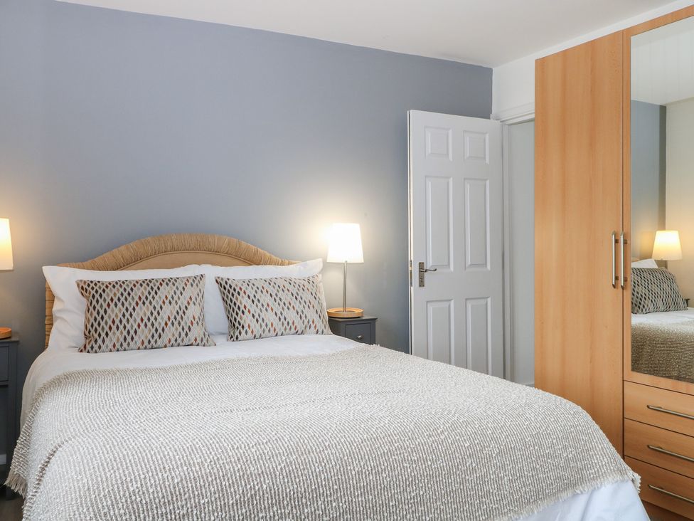 A bedroom with a bed and a wardrobe at The Annex in Slough