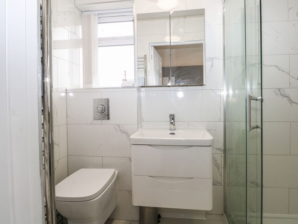 A bathroom with a shower, sink, and toilet at The Annex in Slough