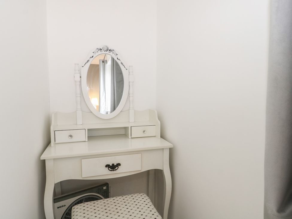 A vanity table with a mirror and drawer in a bedroom at The Annex in Slough