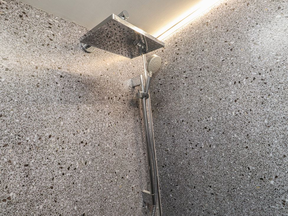 A shower with a shower head and hose at Caban Tan Y Ffawydd in Chwilog near Y Ffor