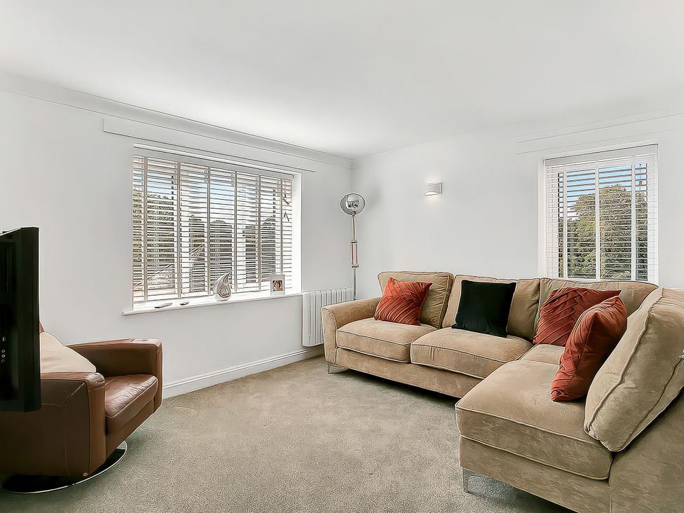 A living room with a sofa and television at 40 Raleigh Court in Sherborne