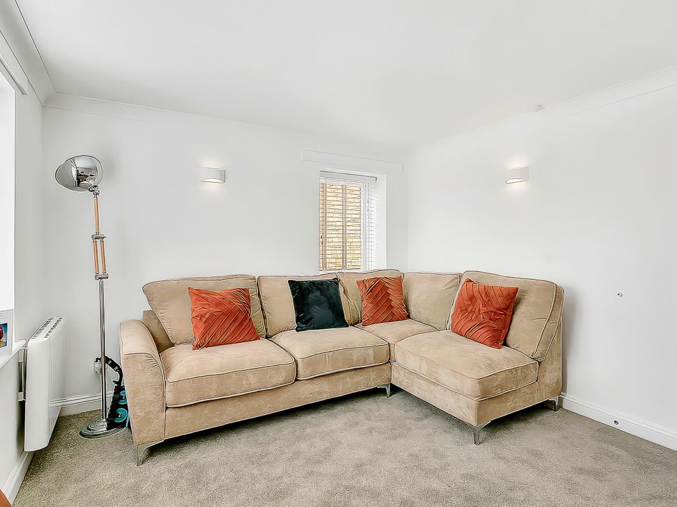 A living room with a sofa and throw pillows at 40 Raleigh Court in Sherborne