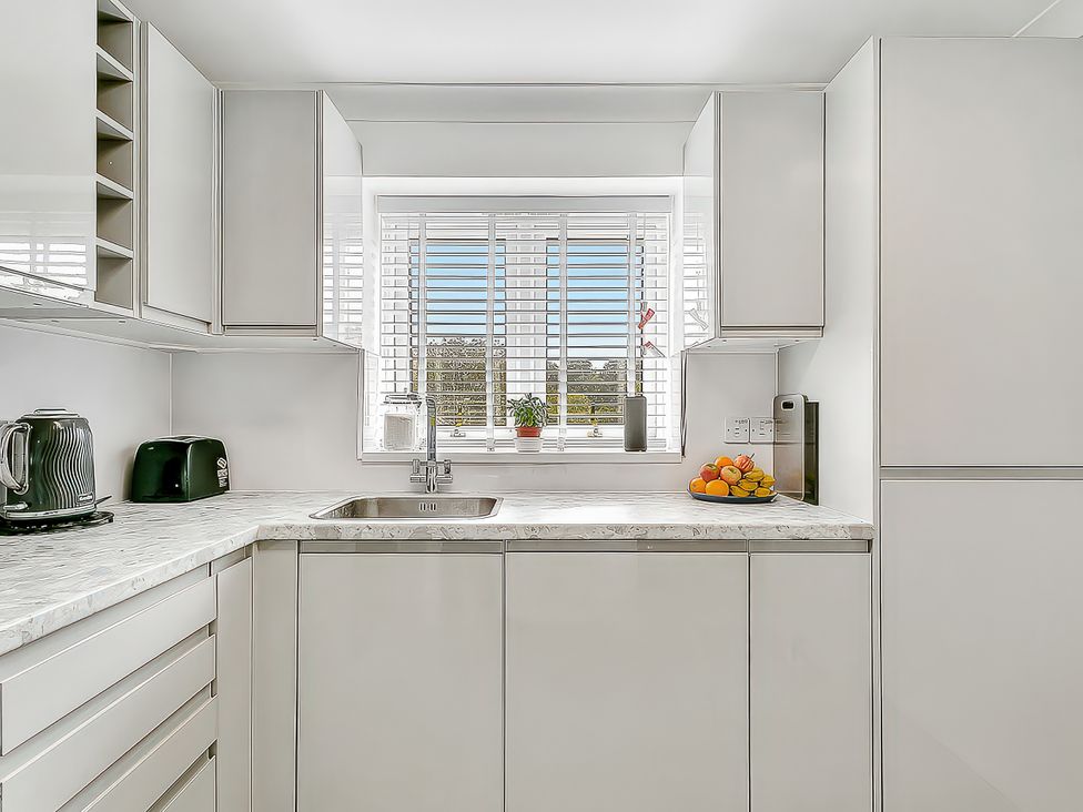 A kitchen with a sink and kettle at 40 Raleigh Court in Sherborne