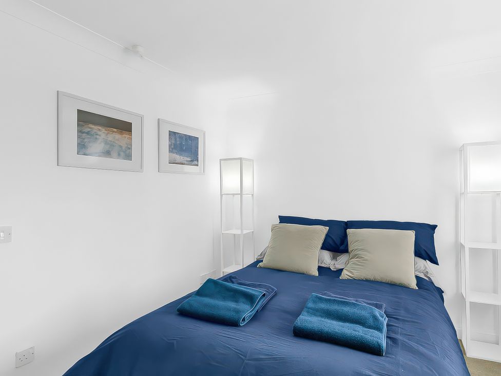 A bedroom with a bed and pillows at 40 Raleigh Court in Sherborne