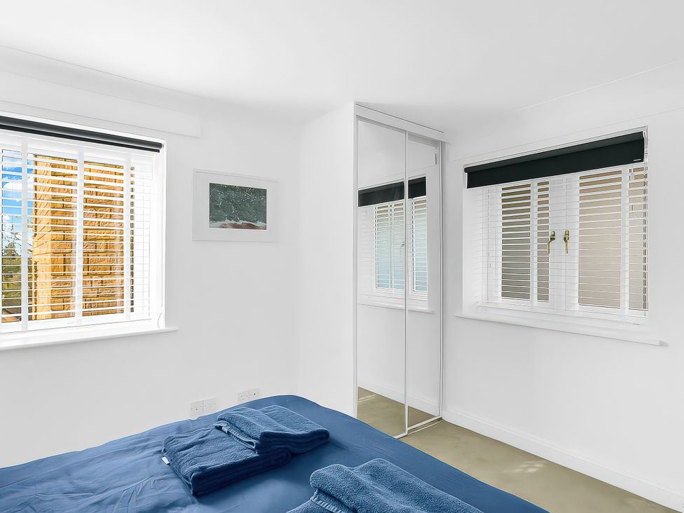 A bedroom with a bed and towels on it at 40 Raleigh Court Sherborne