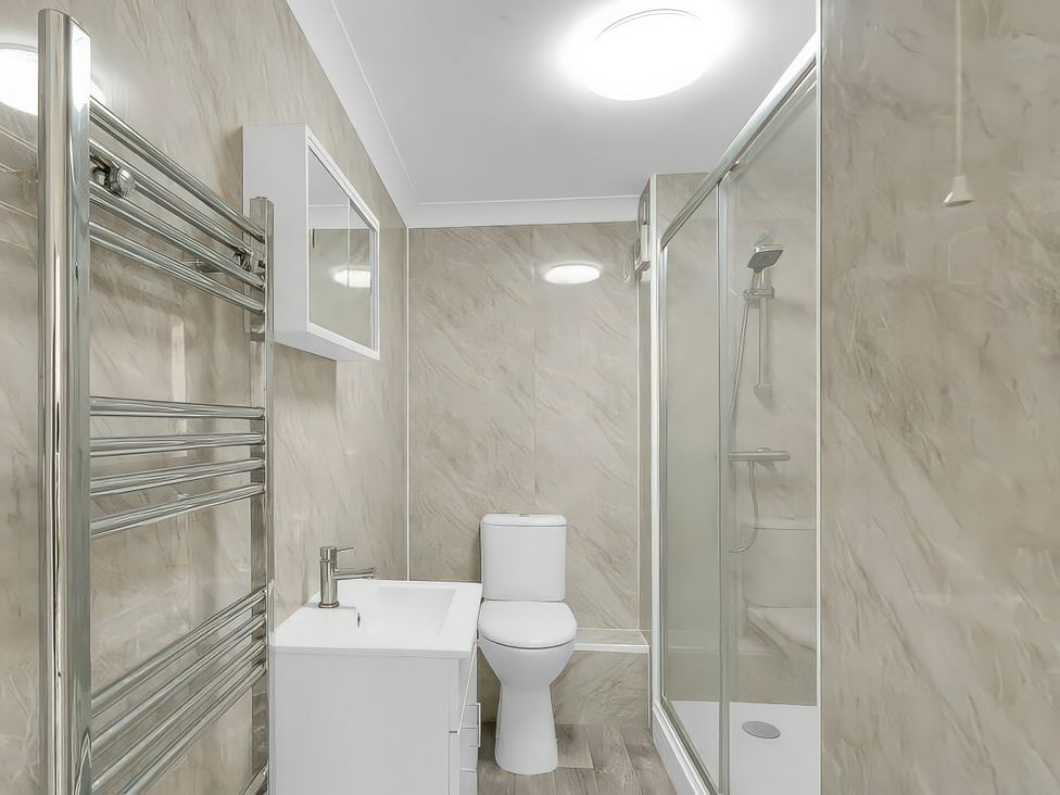 A bathroom with shower, toilet, and sink at 40 Raleigh Court in Sherborne