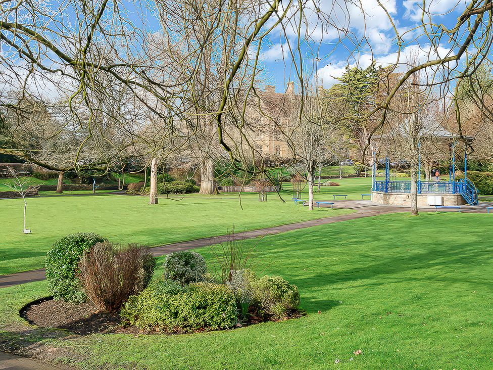 A park with trees and a bandstand at 40 Raleigh Court in Sherborne