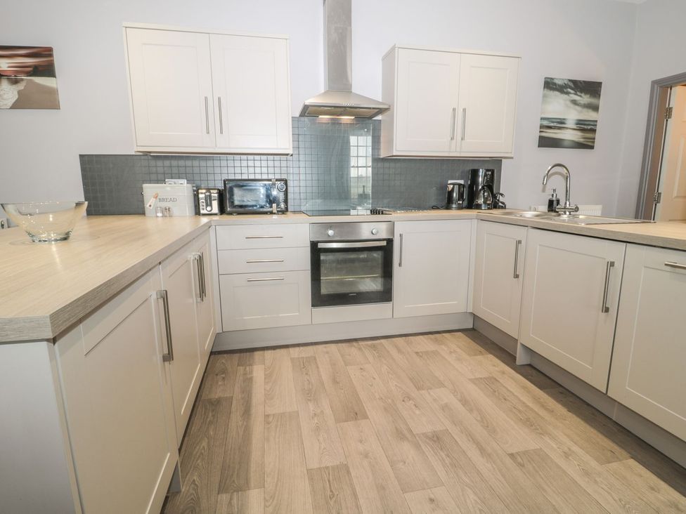 A kitchen with appliances and cabinets at The Sea Chest in Alnmouth