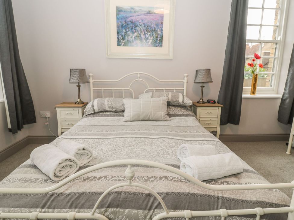 A bedroom with a bed and bedside tables at The Sea Chest in Alnmouth