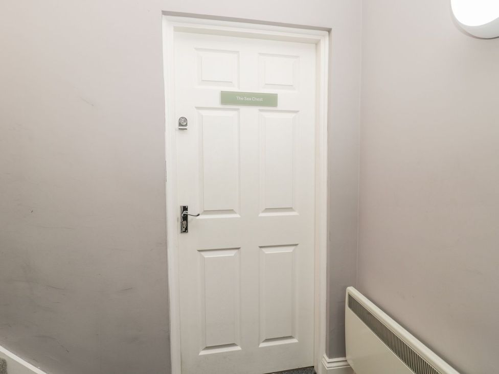 A door with a nameplate in a hallway at The Sea Chest in Alnmouth