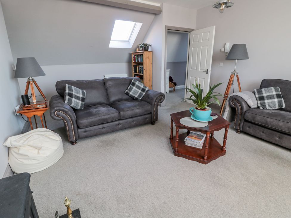 A living room with sofas and a table at Sunset Point in Alnwick