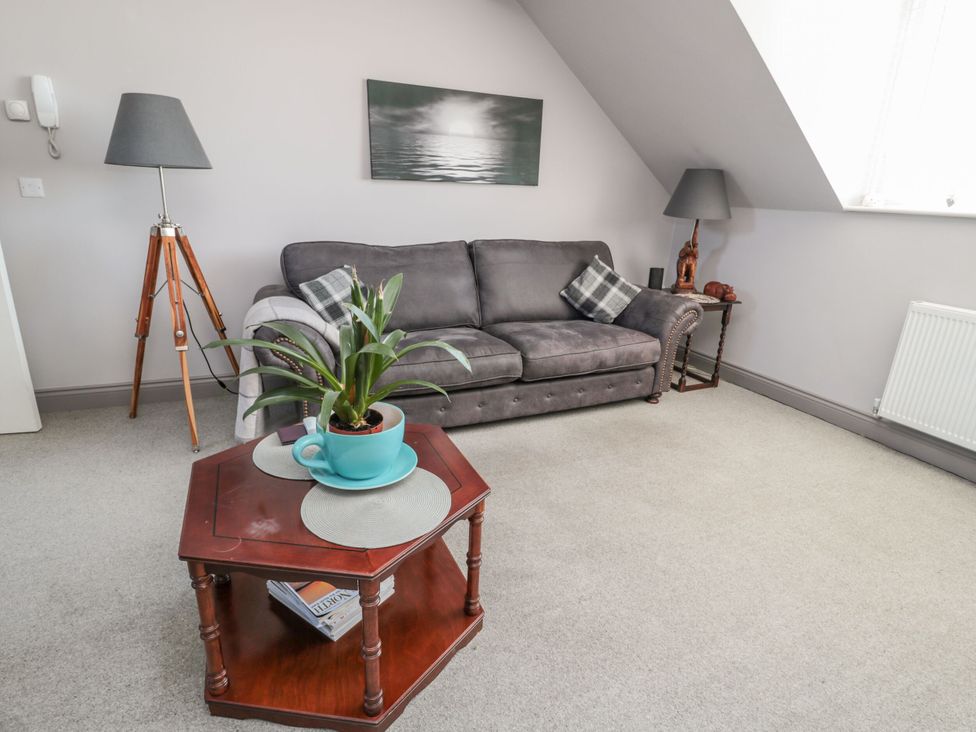 A living room with a sofa and coffee table at Sunset Point in Alnwick
