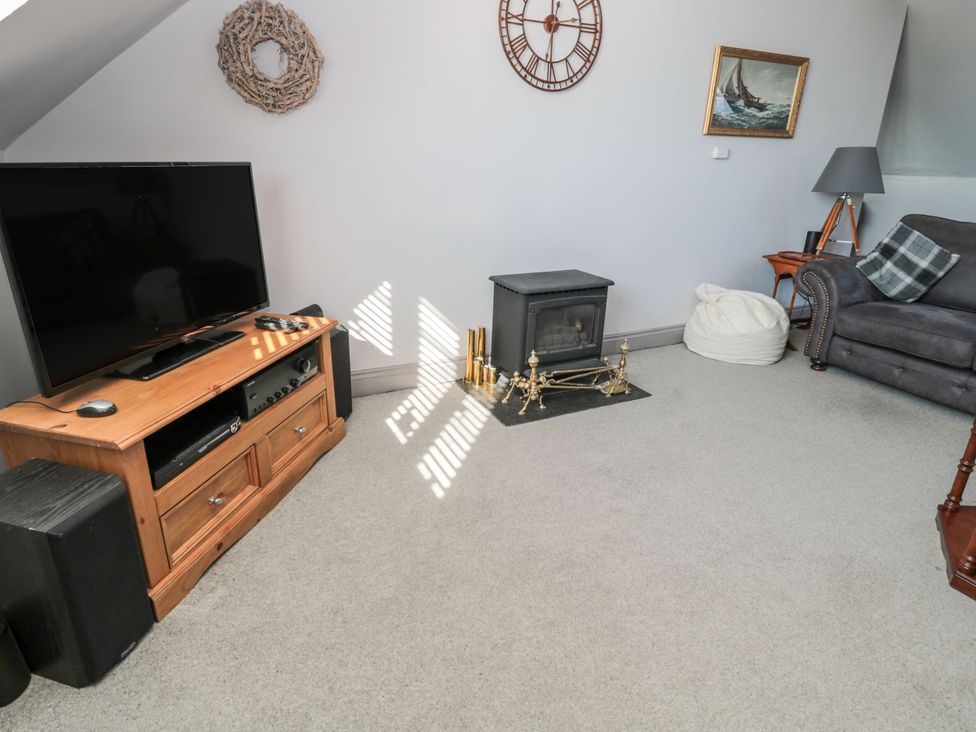 A living room with a television and sofa at Sunset Point in Alnwick