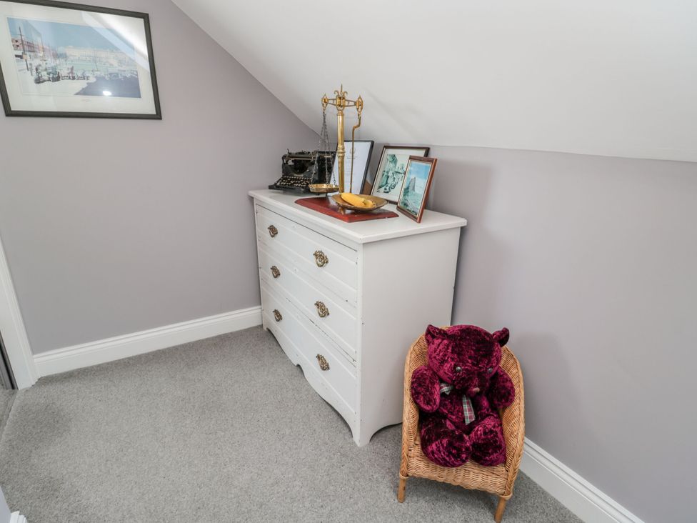 A bedroom featuring a dresser and a stuffed animal at Sunset Point in Alnwick