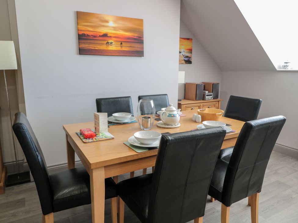 A dining room with a table set for meals at Sunset Point in Alnwick