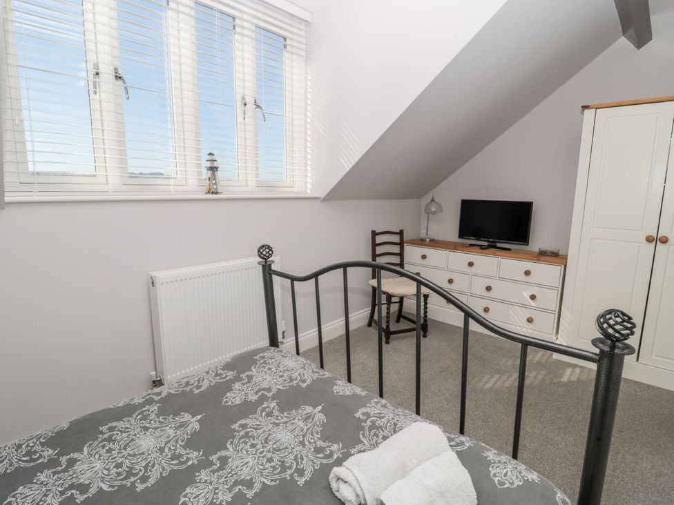 A bedroom with a bed and a television at Sunset Point in Alnwick