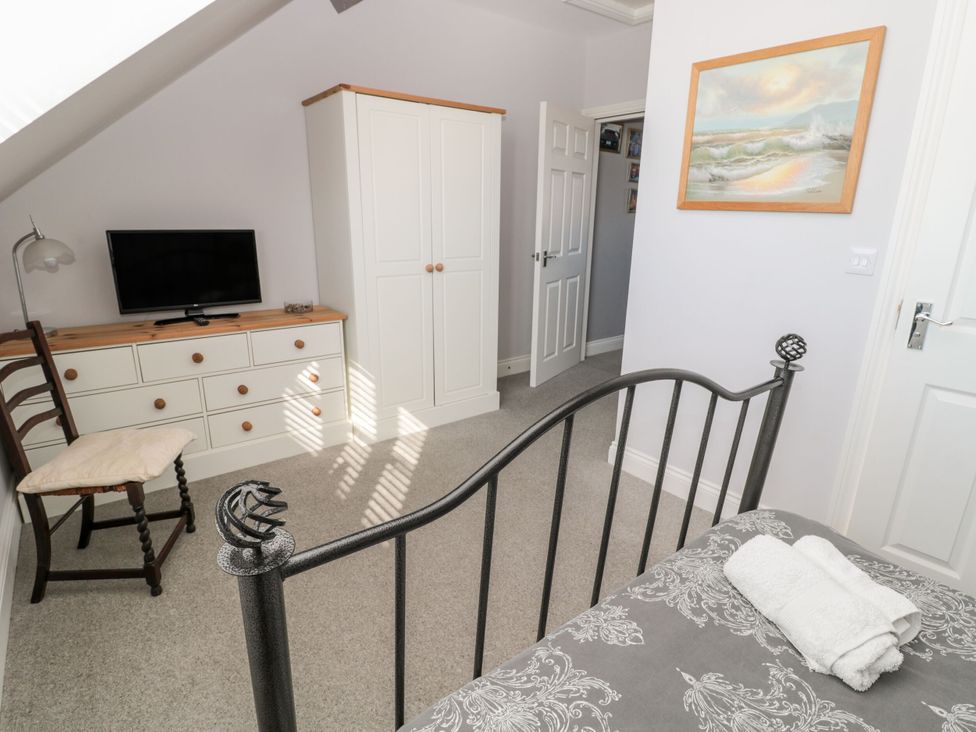 A bedroom with a bed, dresser, and television at Sunset Point in Alnwick