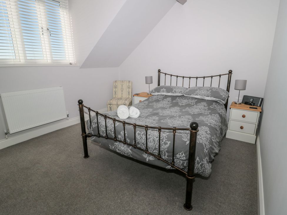 A bedroom with a bed and bedside table at Sunset Point in Alnwick