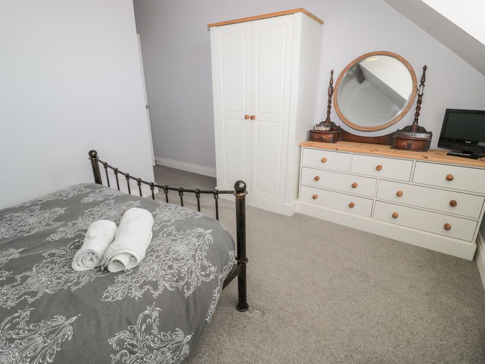 A bedroom with a bed and storage units at Sunset Point in Alnwick