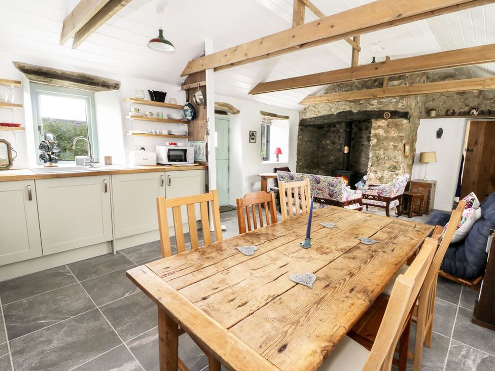 A kitchen with wooden table and chairs at Rhos Y Clegryn in Goodwick