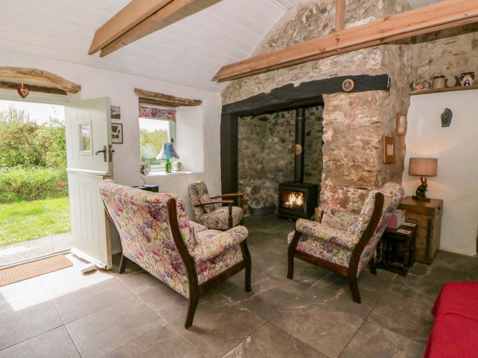 A living room with a fireplace and seating area at Rhos Y Clegyrn in Goodwick