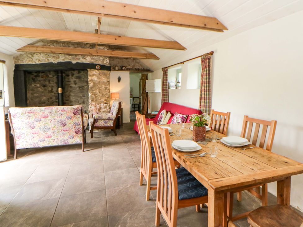 A dining room with a table and chairs at Rhos Y Clegyrn in Goodwick