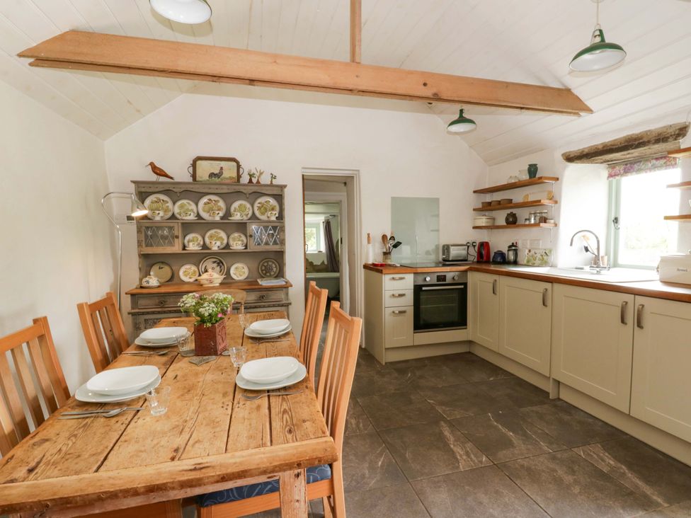 A kitchen with a dining table and chairs at Rhos Y Clegyrn in Goodwick