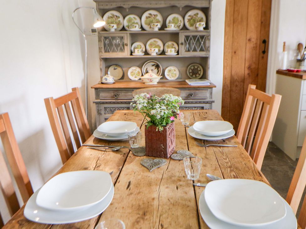 A dining room with a table set for four at Rhos Y Clegyrn in Goodwick