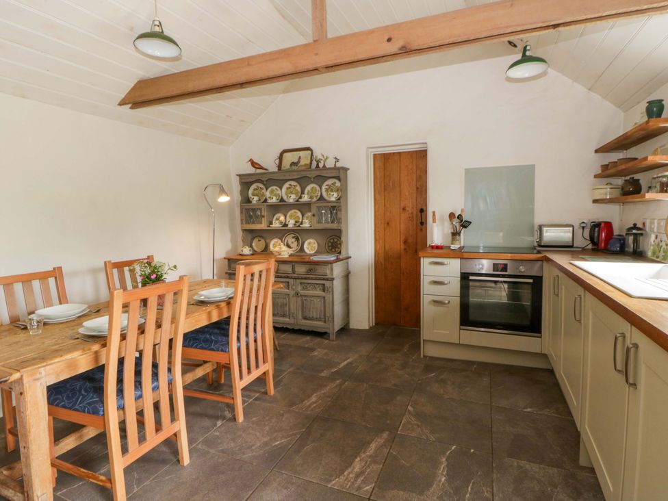 A kitchen with a dining table and chairs at Rhos Y Clegyrn Goodwick