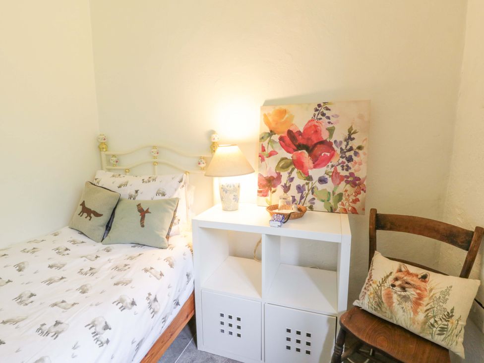 A bedroom with a bed and shelf at Rhos Y Clegyrn Goodwick