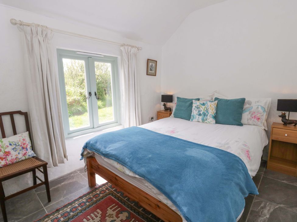 A bedroom with a bed and window at Rhos Y Clegyrn in Goodwick